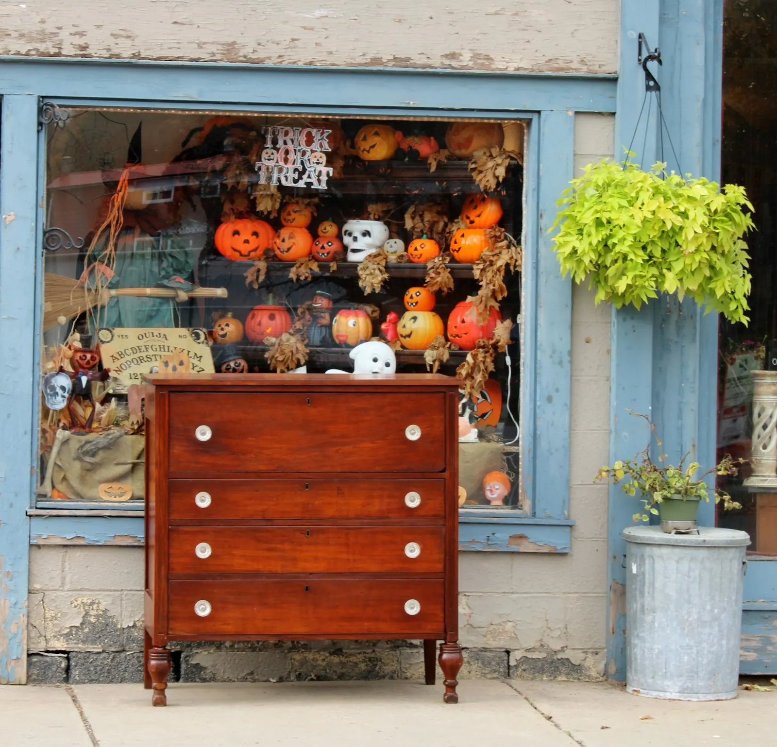 A red vintage chest of drawers outside a shop window
