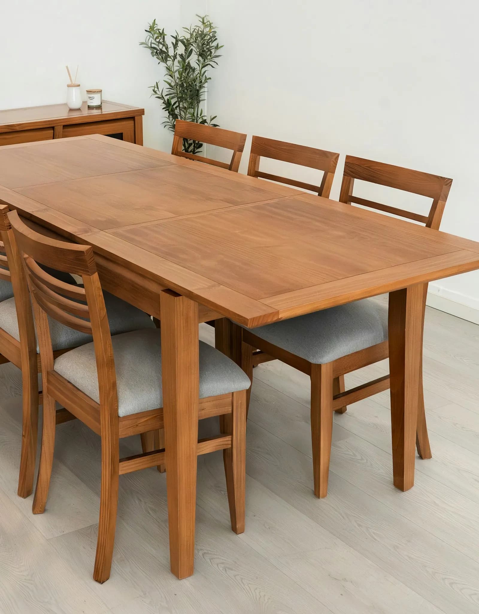 A wooden dining table with four chairs