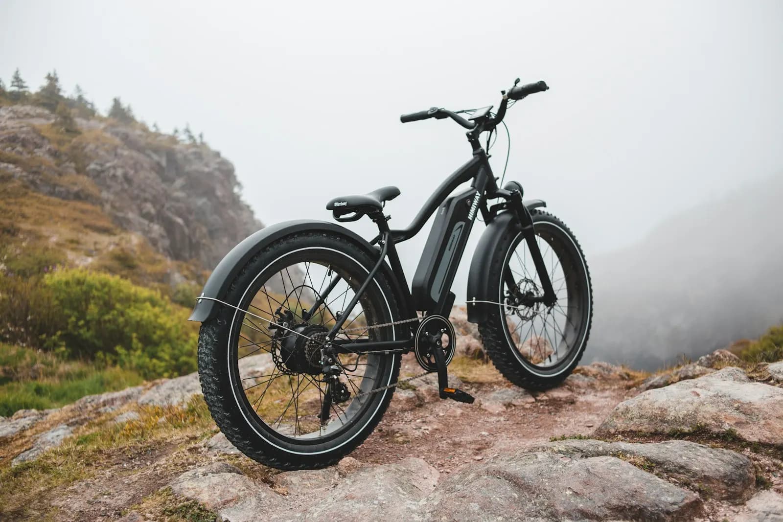 A fat-tire e-bike parked on a rocky hillside