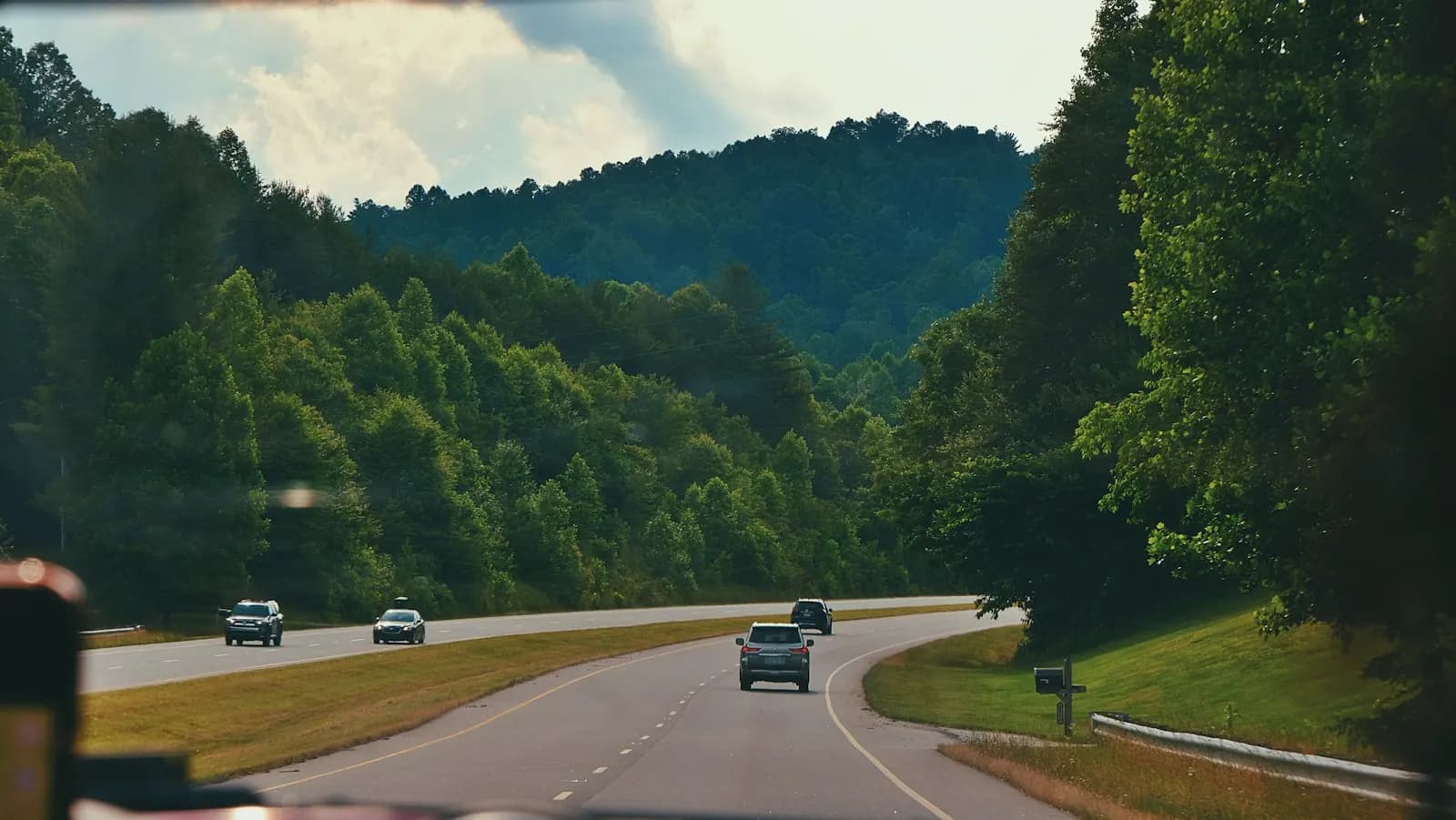 A divided highway through wooded hills