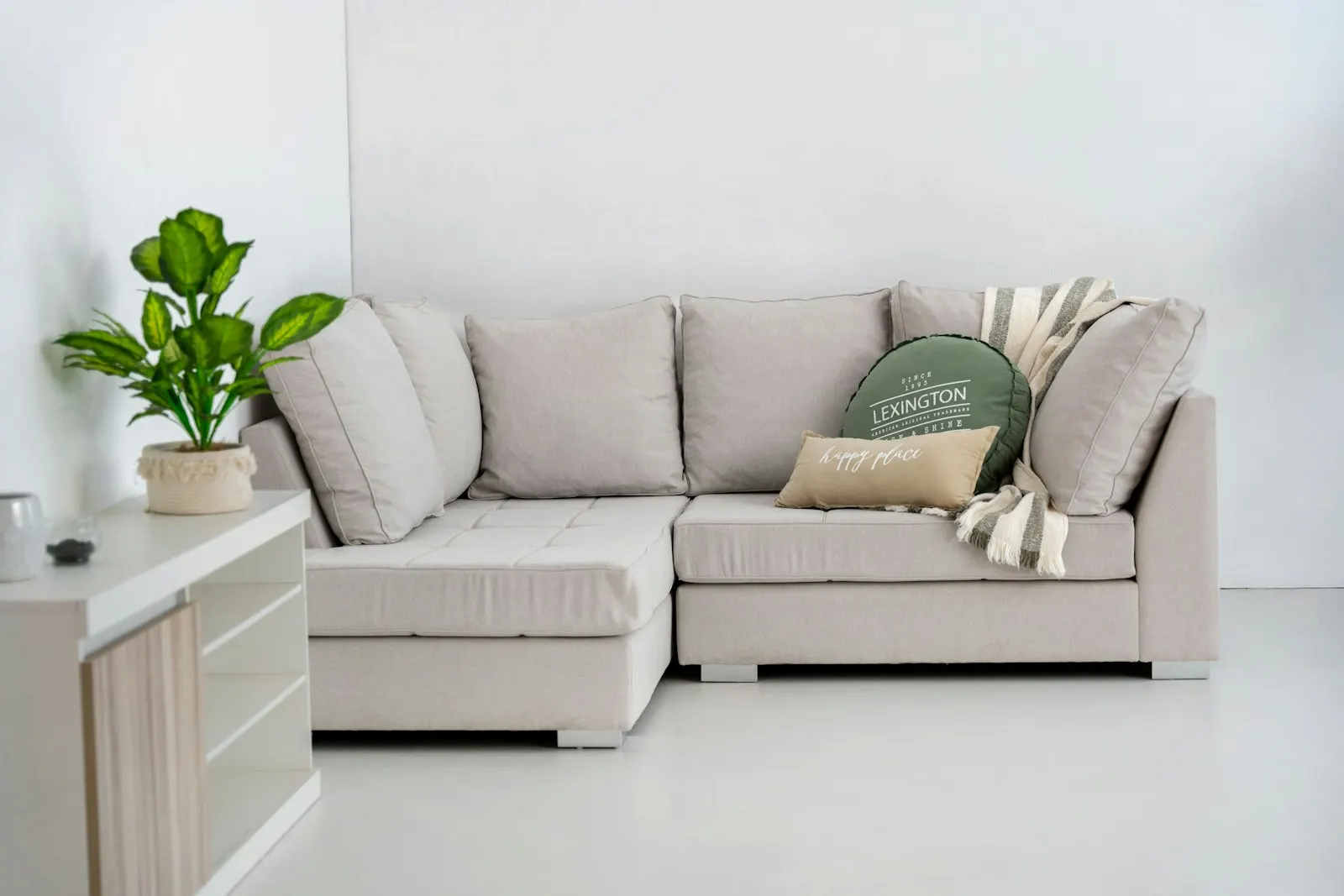 A light grey L-shaped sectional sofa with cushions